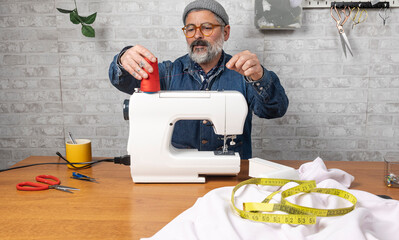 Man threading a sewing machine for tailoring project