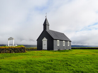 B&uacute;&eth;akirkja or Black church of Budir, old wooden church, with white door, windows and gate and was established in 1703. B&uacute;&eth;ir, Sn&aelig;fellsnes Peninsula. One of the most photographed churches in Iceland.