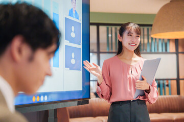 モダンオフィスでプレゼンをする若い女性