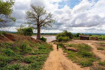 Madagascar, a sandy path leads down to th river in a village located on the river Tsibirihina.