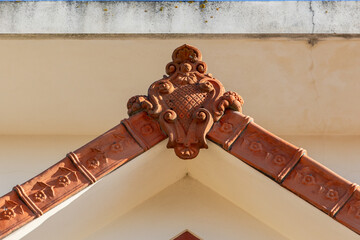 Ornate terracotta roof ridge detail on traditional coastal house in Furadouro Portugal