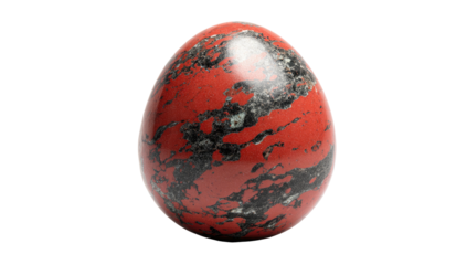 A close-up shot of a speckled, egg-shaped object, showing red and black mottled patterns