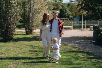 Happy family walking in park, enjoying parenthood and leisure