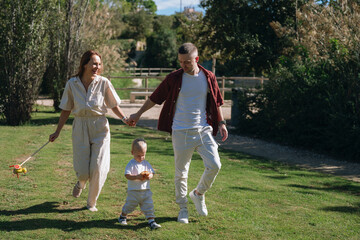 Family walking together on green grass surface