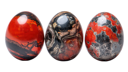 Three polished oval stones with varying patterns of red, black, brown, and grey on a black background