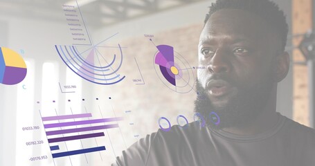 Reaching man wearing dark athletic tee interacting with AR data overlays in gym loft, copy space