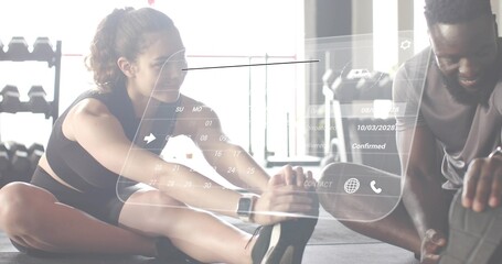 Stretching woman wearing black sports bra and man wearing grey tee on gym floor, HUD overlay