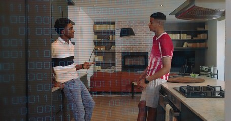 Talking two men in kitchen in white and red striped shirts, holding smartphone with binary overlay