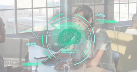 Smiling Asian woman in light blouse leaning, talking at sunlit office with laptop brain HUD