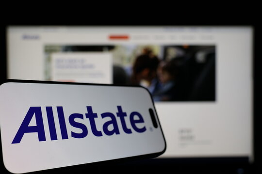 Kiel, Germany - 01-12-2026: Smartphone displaying Allstate logo in front of the company website on a monitor