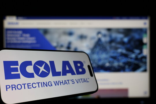 Kiel, Germany - 01-12-2026: Smartphone displaying Ecolab logo in front of the company website on a monitor