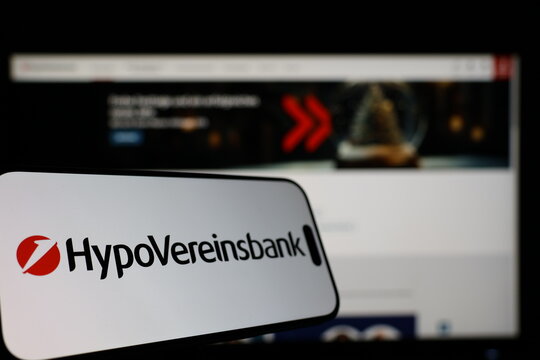 Kiel, Germany - 01-12-2026: Smartphone displaying HypoVereinsbank logo in front of the company website on a monitor