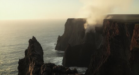 Dramatic volcanic cliffs meet misty ocean