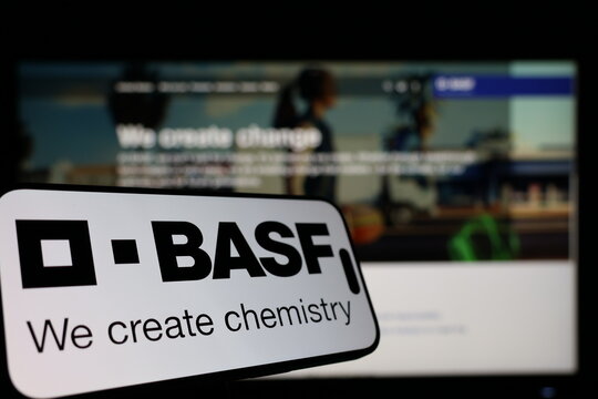 Kiel, Germany - 01-12-2026: Smartphone displaying BASF logo in front of the company website on a monitor