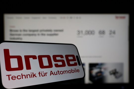 Kiel, Germany - 01-12-2026: Smartphone displaying Brose Group logo in front of the company website on a monitor