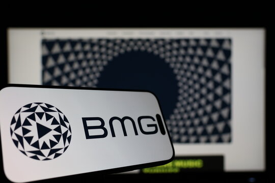 Kiel, Germany - 01-12-2026: Smartphone displaying BMG logo in front of the company website on a monitor