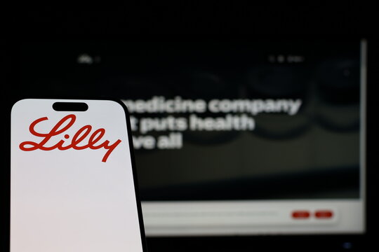 Kiel, Germany - 01-12-2026: Smartphone displaying Eli Lilly & Co. logo in front of the company website on a monitor