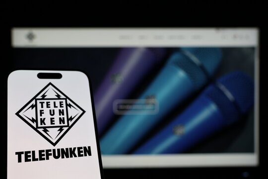 Kiel, Germany - 01-12-2026: Smartphone displaying Telefunken logo in front of the company website on a monitor