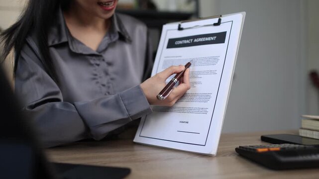 A Hispanic real estate agent uses a laptop to help a partner search online listings for a dream residential property.