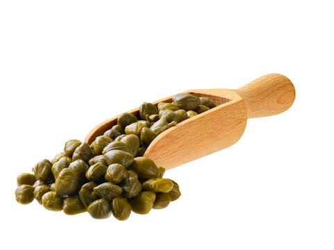 Marinated capers in a wooden spoon isolated on a white background.
