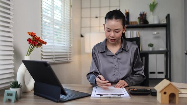 A Hispanic real estate agent uses a laptop to help a partner search online listings for a dream residential property.