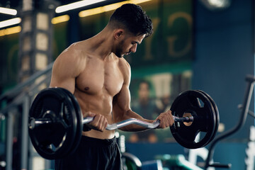Handsome Arab Man With Naked Torso Lifting Heavy Barbell At Gym, Muscular Middle Eastern...