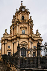 Duomo Di San Giorgio In Ragusa, Sicily: Monumental Baroque Cathedral Facade With Ornate Sculptures, Curved Staircase, And Historic Stone Architecture