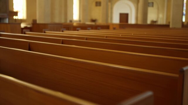 A serene video showcasing rows of wooden pews in a peaceful church interior with natural light