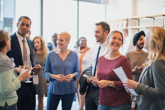 Group of diverse people meeting socializing at social event, Diverse people meeting and enjoying conversation and drink. Diverse men and women Mixed genders and ethnicities in Casual and formal attire