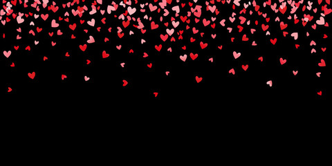a large number of red and pink hearts floating on black background