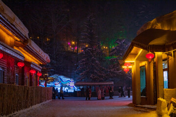 Snowy winter festival night market at  Xuexiang China snow town.