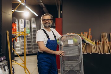 Handyman working at hardware store carrying step stool