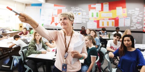 Classroom with diverse students and a teacher pointing at a board. Engaged students, attentive teacher, educational setting, learning environment. Teacher classroom and education concept.