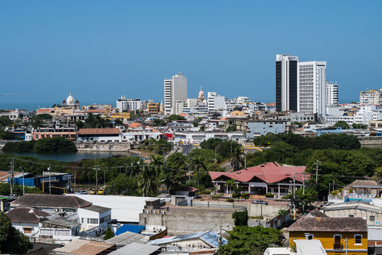View of diverse architecture with modern skyscrapers and colonial buildings under a clear blue sky, Cartagena, Bolivar, Colombia.