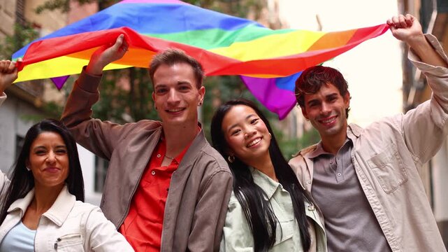 Diverse group of friends celebrating pride with rainbow flag