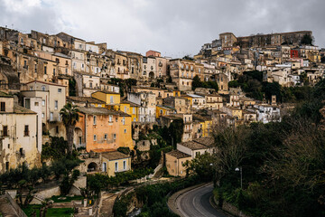 Hilltop City Of Ragusa In Sicily Under Overcast Sky: Historic Stone Buildings And Dense Urban Landscape In Soft Diffused Light And Hazy Weather