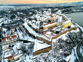 Aerial Sunset View of Petrovaradin Fortress Covered in Snow over the Danube River, Novi Sad, Serbia