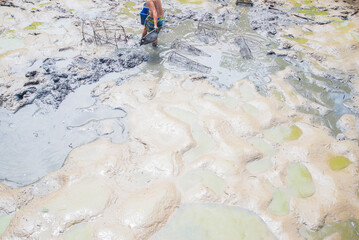 Workers are working in the mud at the construction site of a new house.