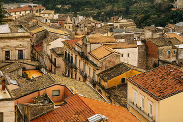 Panoramic View Over Ragusa From Cathedral Of San Giovanni Battista: Historic Sicilian City Rooftops, Church Domes, And Dense Stone Architecture Under Overcast Sky