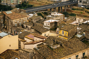 Panoramic View Over Ragusa From Cathedral Of San Giovanni Battista: Historic Sicilian City Rooftops, Church Domes, And Dense Stone Architecture Under Overcast Sky