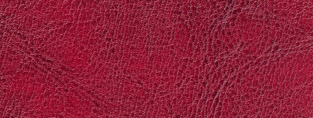 Dark red faux leather texture background with embossed reptile skin pattern. Structure of wine surface, macro