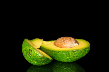 Ripe avocado isolated on black background, close-up.