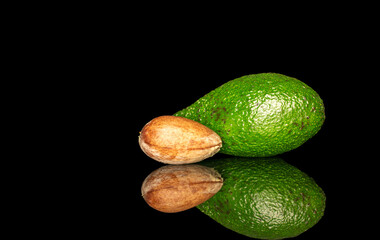 Ripe avocado isolated on black background, close-up.