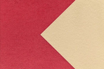 Textured red paper background, half two colors with light beige arrow, macro. Template with copy space for banner