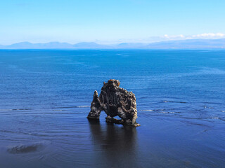 Panoramic view to the H&uacute;nafl&oacute;i Bay, Vatnsnes peninsula with iconic Hv&iacute;tserkur basalt stack or &ldquo;white shirt&rdquo; rock, from bird droppings that cover the rock, known as Troll of Northwest Iceland.