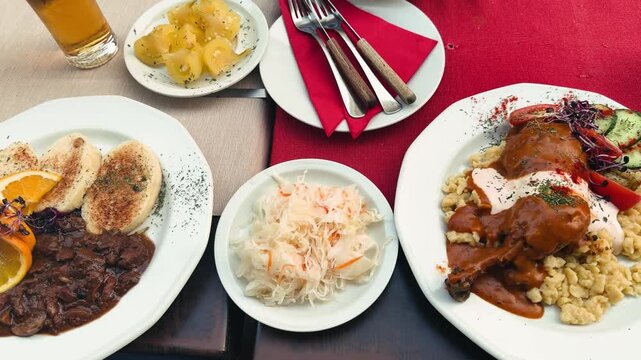 Sauerkraut, pickled hot yellow peppers, braised wild boar in wine with dumplings, and paprikash. Eastern European food is on display at the tavern. High quality 4k footage