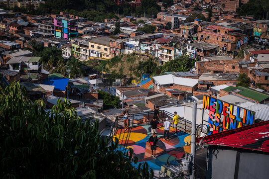 View of vibrant colors dance across rooftops, a lively platform with visitors overlooking the urban tapestry of Comuna 13, Medellin, Colombia.
