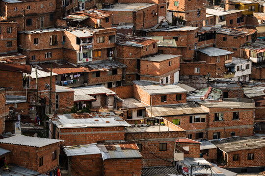 View of the red brick buildings nestled tightly together, creating a maze-like cityscape in Comuna 13, Medellin, Colombia, Medellin, Colombia.