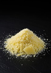 Heap of fresh, finely grated Parmesan cheese, rich yellow-white texture ready for sprinkling onto pasta, pizza, salad, or soup, healthy, powdery, italian