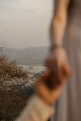 Fototapeta premium A Couple's Embrace Overlooking a Serene Lake and Distant Mountains at Sunset, Sharing a Moment of Love and Connection During a Peaceful Journey